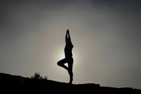 A person is doing yoga on the hill