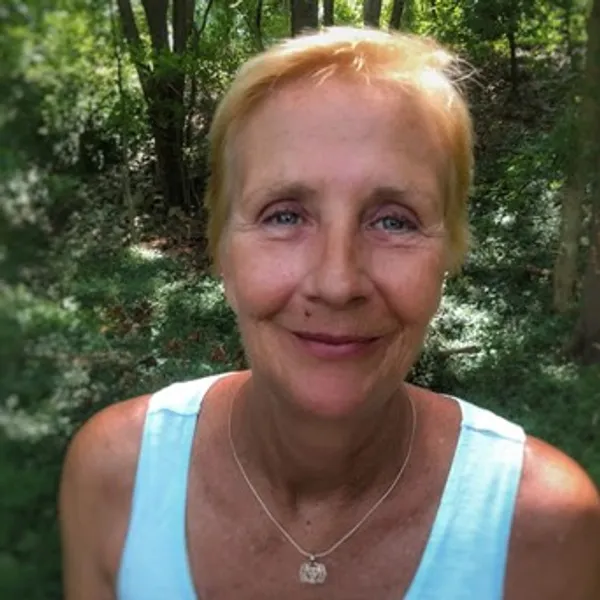 A woman with blonde hair and wearing a blue shirt.