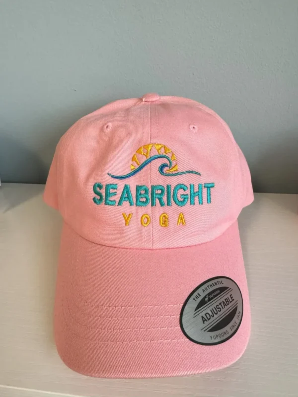 A pink hat with the word " seabright " on it.