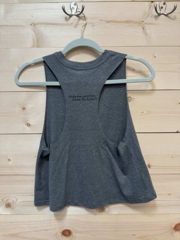 A gray tank top hanging on a clothes rack.